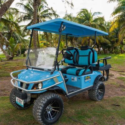 a blue truck driving down a dirt road