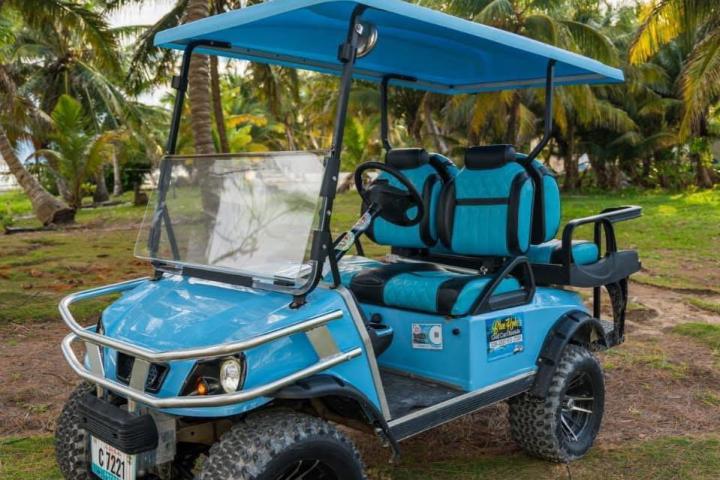 a blue truck driving down a dirt road