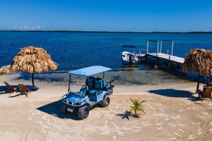 an umbrella sitting on top of a sandy beach next to the ocean